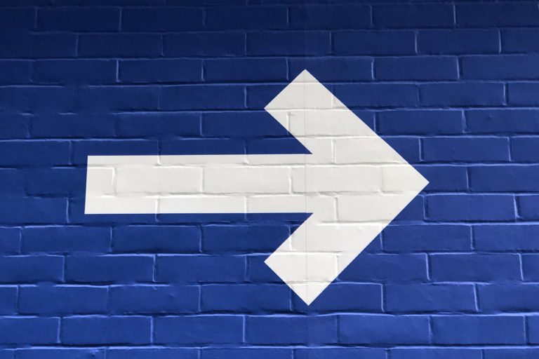white arrow pointing right with a blue background