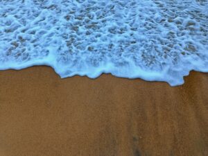 Foaming water on sand