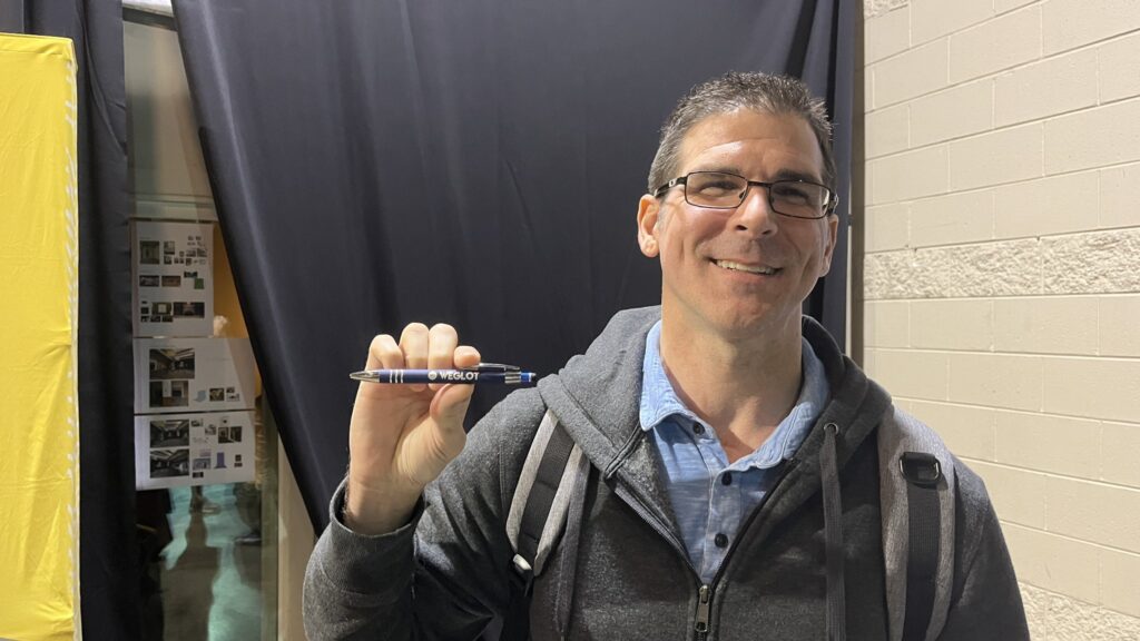 Man holding up a pen